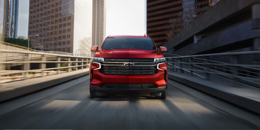 New Chevrolet Tahoe in red driving down a ramp
