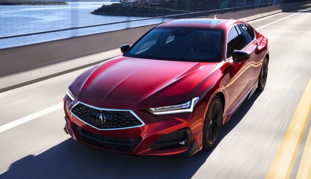 New Acura TLX in red driving across a bridge