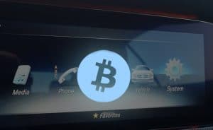 bitcoin logo overlay on vehicle display screen
